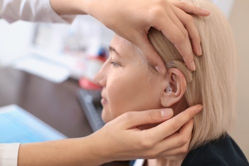A woman being fitted with a hearing aid